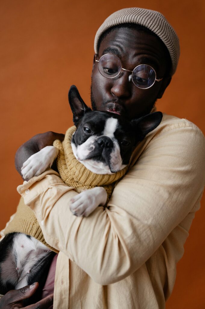 pexels-photo-7533377-7533377 Charming portrait of a man lovingly hugging a French Bulldog.